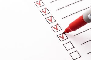 red-pen-marking-items-off-on-a-checklist